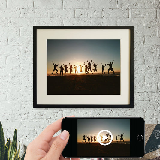 Interactive photo print of friends jumping with sunset behind